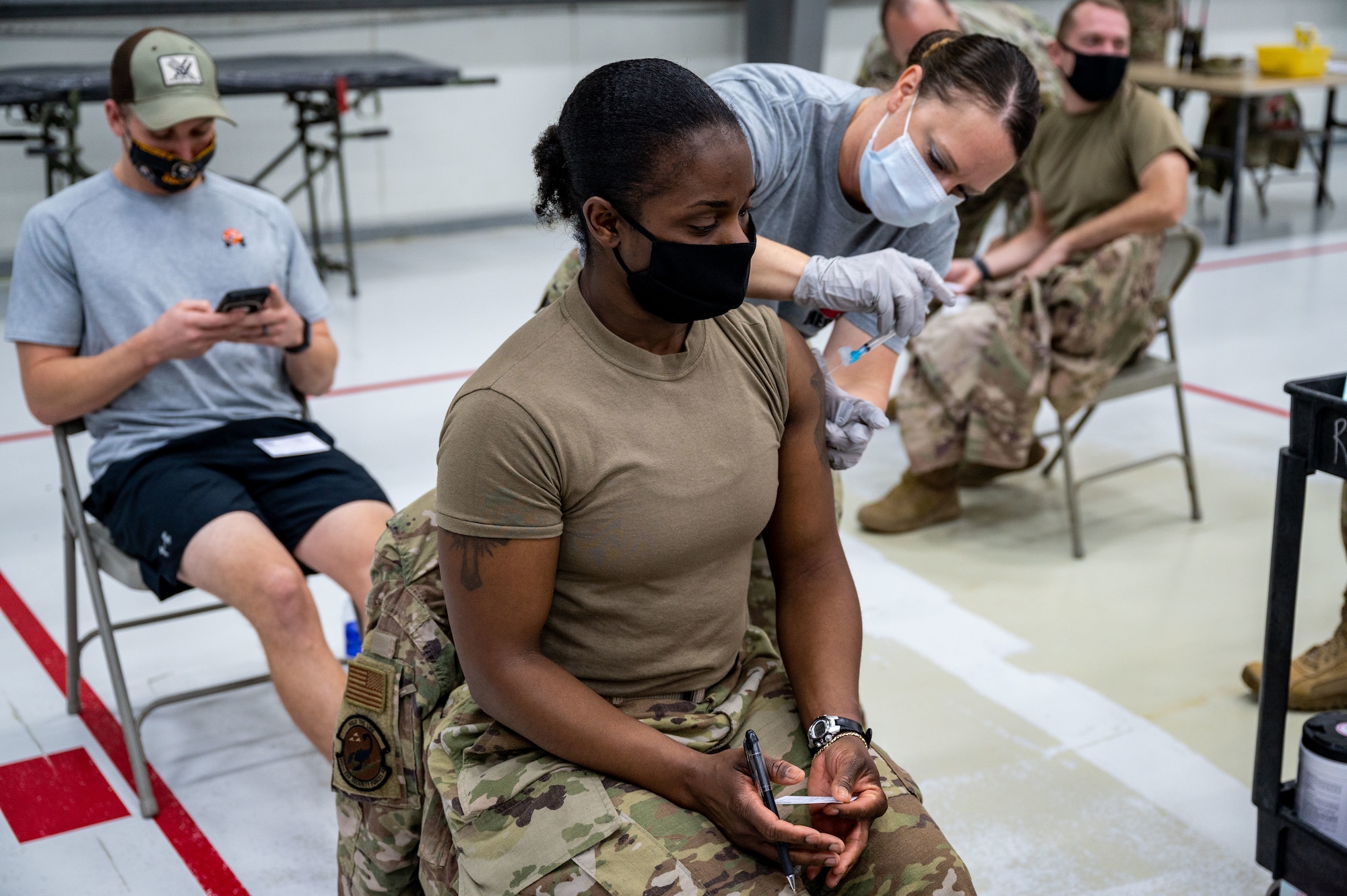 U.S. Air Force Tech. Sgt. Kenisha Lane receives the Johnson & Johnson COVID-19 vaccine