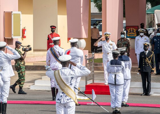 Adm. Robert P. Burke, commander, U.S. Naval Forces Europe and Africa, back right, returns a salute to the procession of the Ghana honor guard during the opening ceremony of Exercise Obangame Express, March 19, 2021.