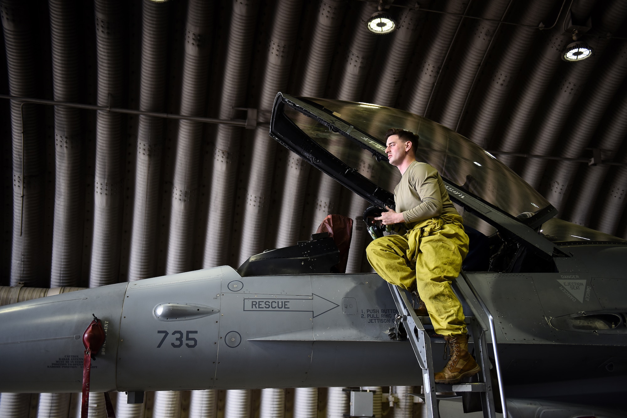 Staff Sgt. Ashley Mounts, 8th Aircraft Maintenance Squadron dedicated crew chief, descends from an F-16 Fighting Falcon after an engine run at Kunsan Air Base, Republic of Korea, March 21, 2021. Crew chiefs inspect, service, clean, and fix aircraft to ensure mission readiness. (U.S. Air Force photo by Senior Airman Suzie Plotnikov)