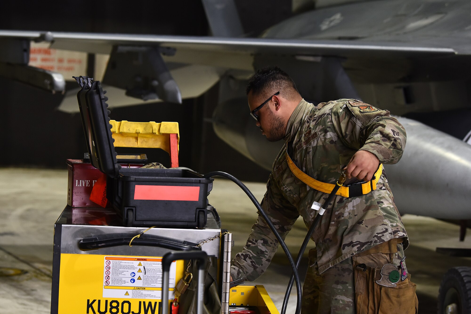 Senior Airman Jose Luna, 8th Aircraft Maintenance Squadron weapons crew member, looks inside a tool cart at Kunsan Air Base, Republic of Korea, March 21, 2021. Maintainers work 24-hour operations to keep F-16 Fighting Falcons mission-ready. (U.S. Air Force photo by Senior Airman Suzie Plotnikov)