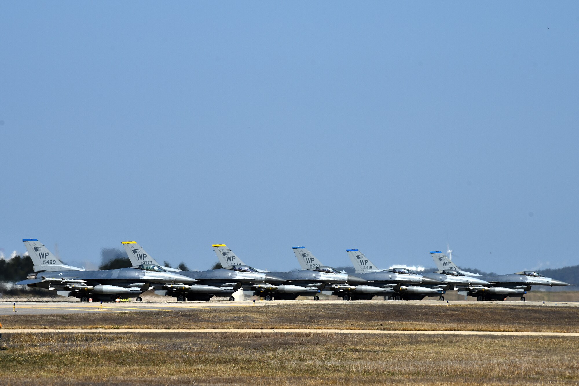 F-16 Fighting Falcons from the 35th Fighter Squadron “Pantons” and 80th Fighter Squadron “Juvats” park on the flightline at Kunsan Air Base, Republic of Korea, March 22, 2021. The F-16 Fighting Falcon is a compact, multi-role fighter aircraft that is highly maneuverable in air-to-air combat and air-to-surface attack. (U.S. Air Force photo by Senior Airman Suzie Plotnikov)
