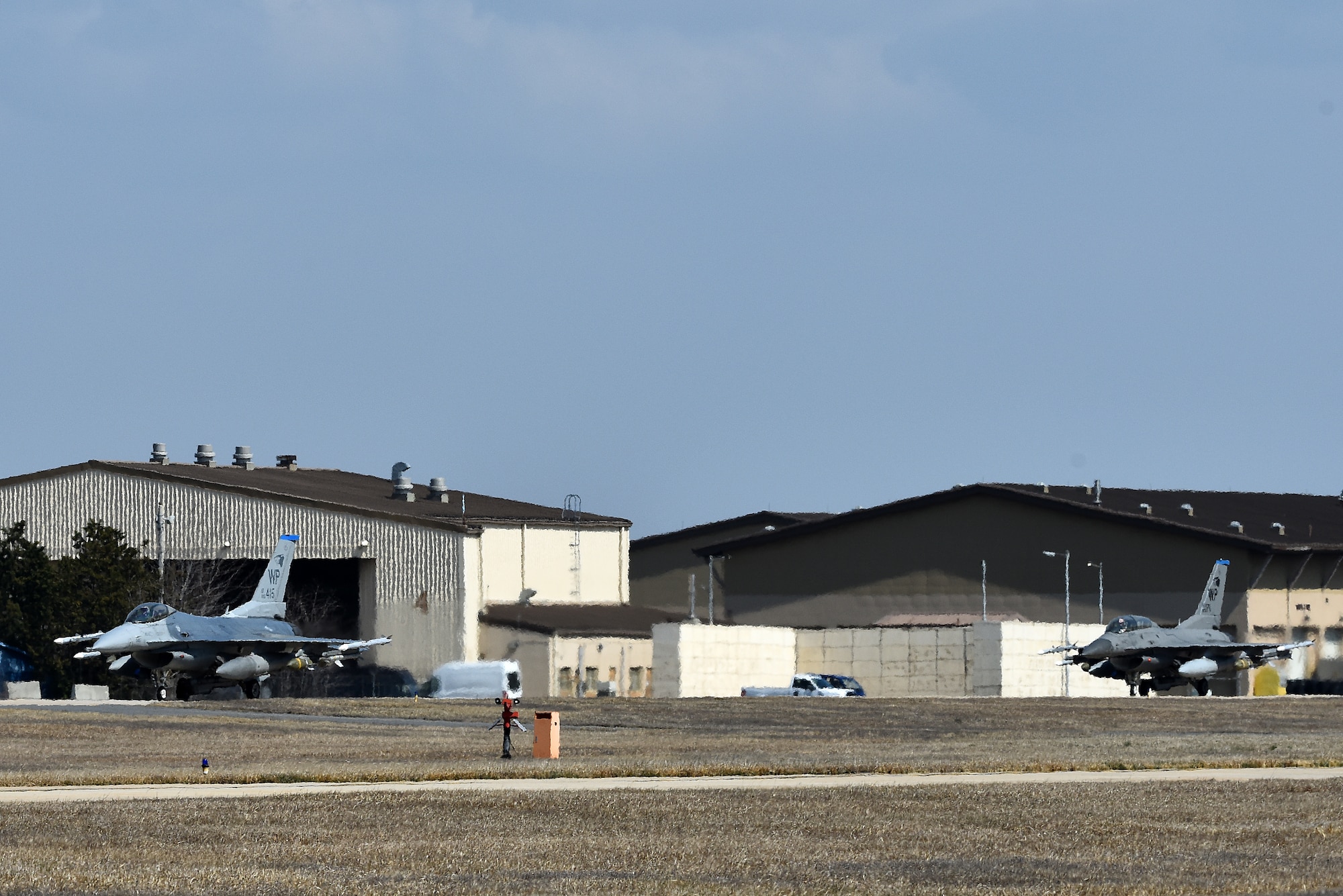 Two F-16 Fighting Falcons from the 35th Fighter Squadron “Juvats” taxi on the flightline at Kunsan Air Base, Republic of Korea, March 22, 2021. The F-16 Fighting Falcon is a compact, multi-role fighter aircraft that is highly maneuverable in air-to-air combat and air-to-surface attack. (U.S. Air Force photo by Senior Airman Suzie Plotnikov)