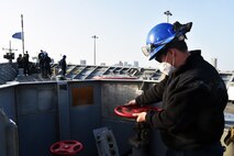 210321-N-IE405-1145 MANAMA, Bahrain (March 21, 2021) - Seaman Nikalus Wagley, assigned to guided-missile cruiser USS Philippine Sea (CG 58), checks the anchor chain brake during a sea and anchor detail prior to the ship departing from Manama, Bahrain, March 21. Philippine Sea is deployed to the U.S.  5th Fleet area of operations in support of naval operations to ensure maritime stability and security in the Central Region, connecting the Mediterranean and Pacific through the western Indian Ocean and three critical chokepoints to the free flow of global commerce. (U.S. Navy photo by Mass Communication Specialist 2nd Class Indra Beaufort/Release)