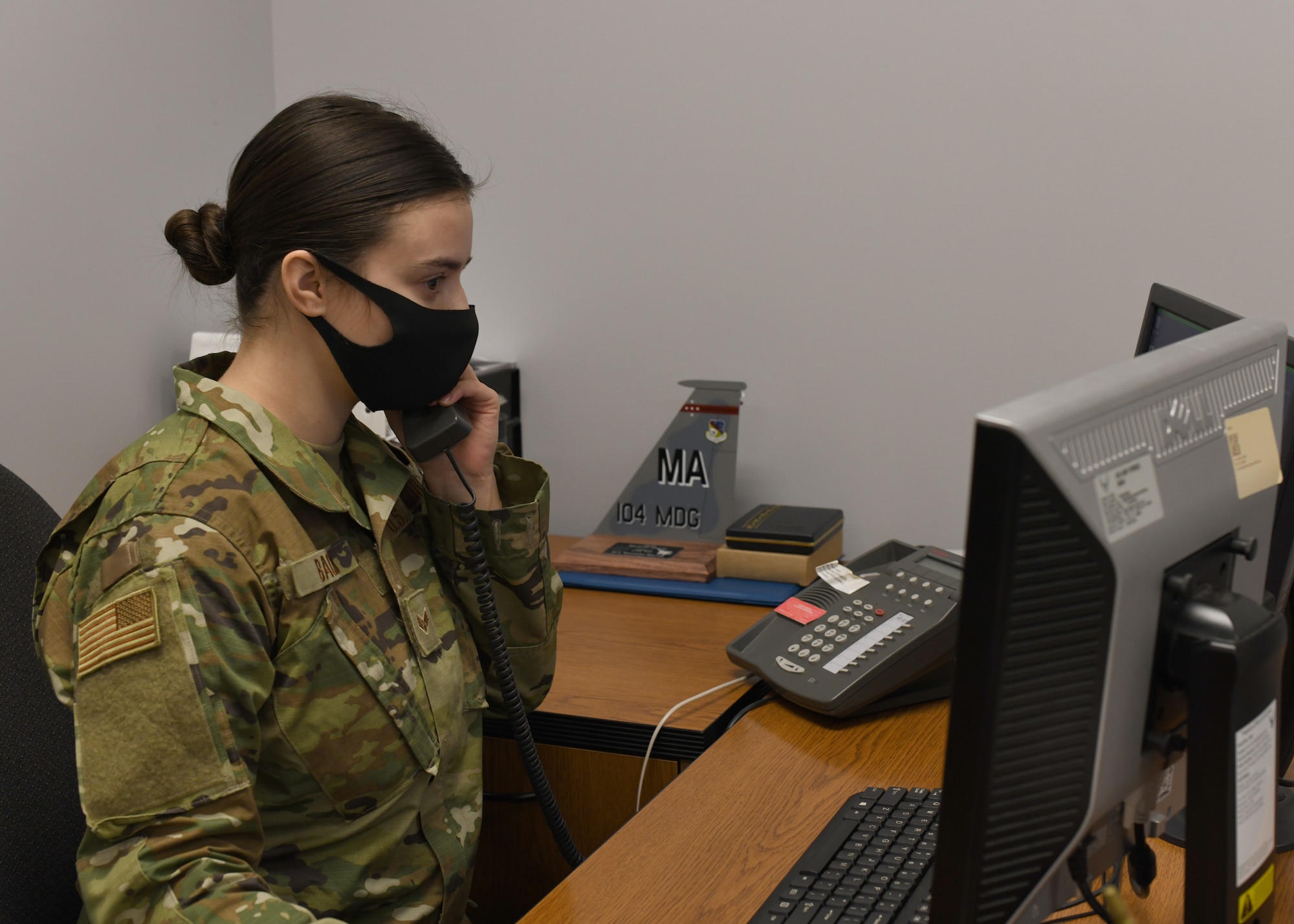 Senior Airman Weronika Baczek, public health technician, 104th Medical Group, answers calls pertaining to possible contact with COVID-19, in her office at Barnes Air National Guard Base, Massachusetts, Feb. 17, 2021. Contact tracing is critical for safeguarding 104th Fighter Wing mission readiness and the health of our Barnestormers and surrounding communities from COVID-19. (U.S. Air National Guard courtesy photo)