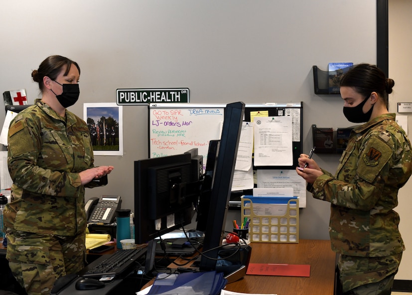 Senior Airman Weronika Baczek, public health technician, 104th Medical Group, discusses updates on the contact tracing program with Master Sgt. Christine Lupacchino, public health flight chief, 104MDG, in Lupacchino’s office at Barnes Air National Guard Base, Massachusetts, Feb. 17, 2021. Contact tracing is critical for safeguarding 104th Fighter Wing mission readiness and the health of our Barnestormers and surrounding communities from COVID-19. (U.S. Air National Guard courtesy photo)