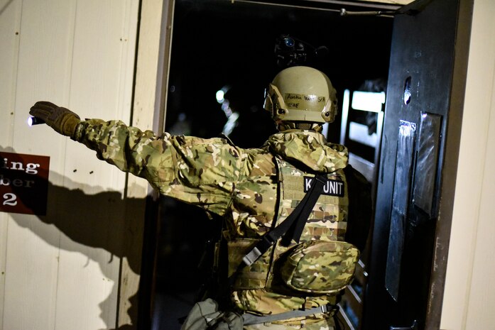 An Airman searches a building.
