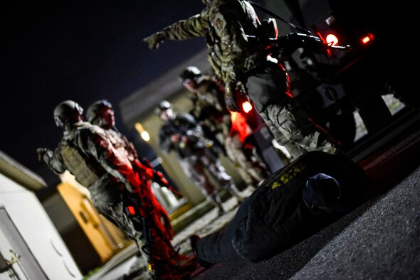 Airmen detain a simulated adversary.
