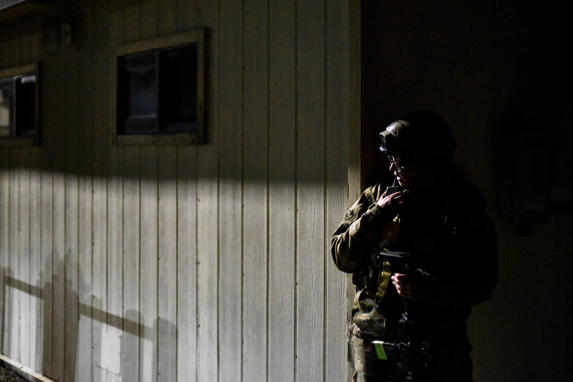 An Airman speaks through a radio.