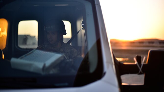 A maintainer waits to pick up Airmen during shift changeover.