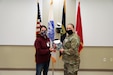 Shelby Rangel, Center Director for the Ft. Bragg USO, presents Sgt. Teresa Gonzalez, S1 NCOIC for the 1st Civil Affairs and Psychological Operations Training Brigade, with a USO sponsored gift bag. Gonzalez was nominated by her coworker, Ms. Kristen Bell, and recognized by the USO as one of thirty female servicemembers across Ft. Bragg to be honored during Women’s History month.