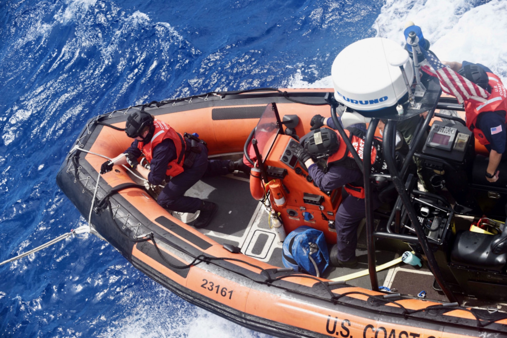 U.S. Coast Guard Petty Officer 3rd Class Alexandra Hartman prepares to release the tether lines on one of the USCGC Stone's (WMSL 758) small boats for launch off the coast of Northern Brazil on Jan. 14, 2021. The Stone conducted training with the Brazilian navy ship Guaiba and shared rescue and law enforcement methods. (U.S. Coast Guard photo by Petty Officer 3rd Class John Hightower)