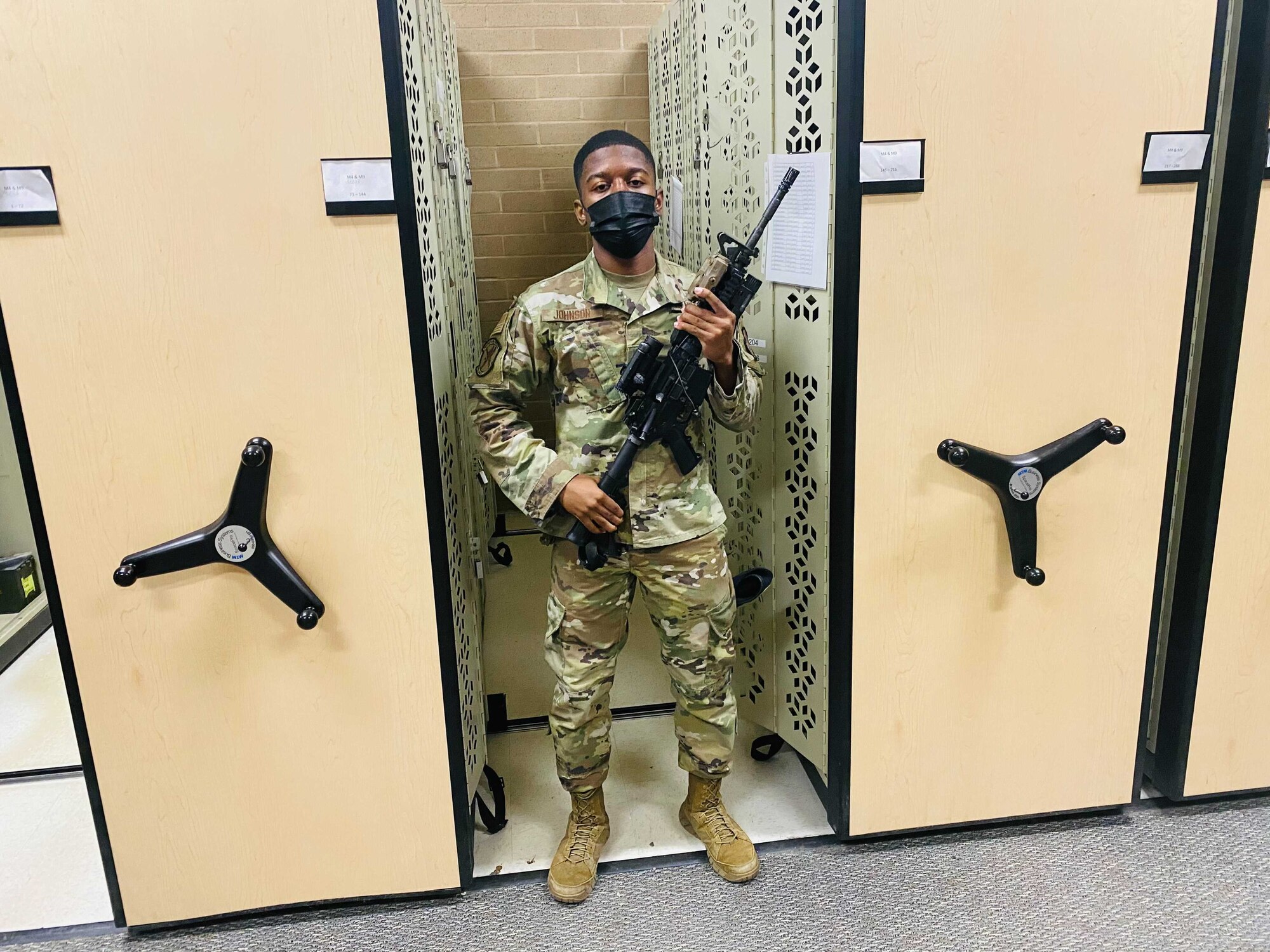 Airman First Class Kamari Johnson, a defender with the 75th Security Forces Squadron, holds a rifle in the security forces armory to be issued to a patrolman, March 18, 2021, at Hill Air Force Base, Utah.
