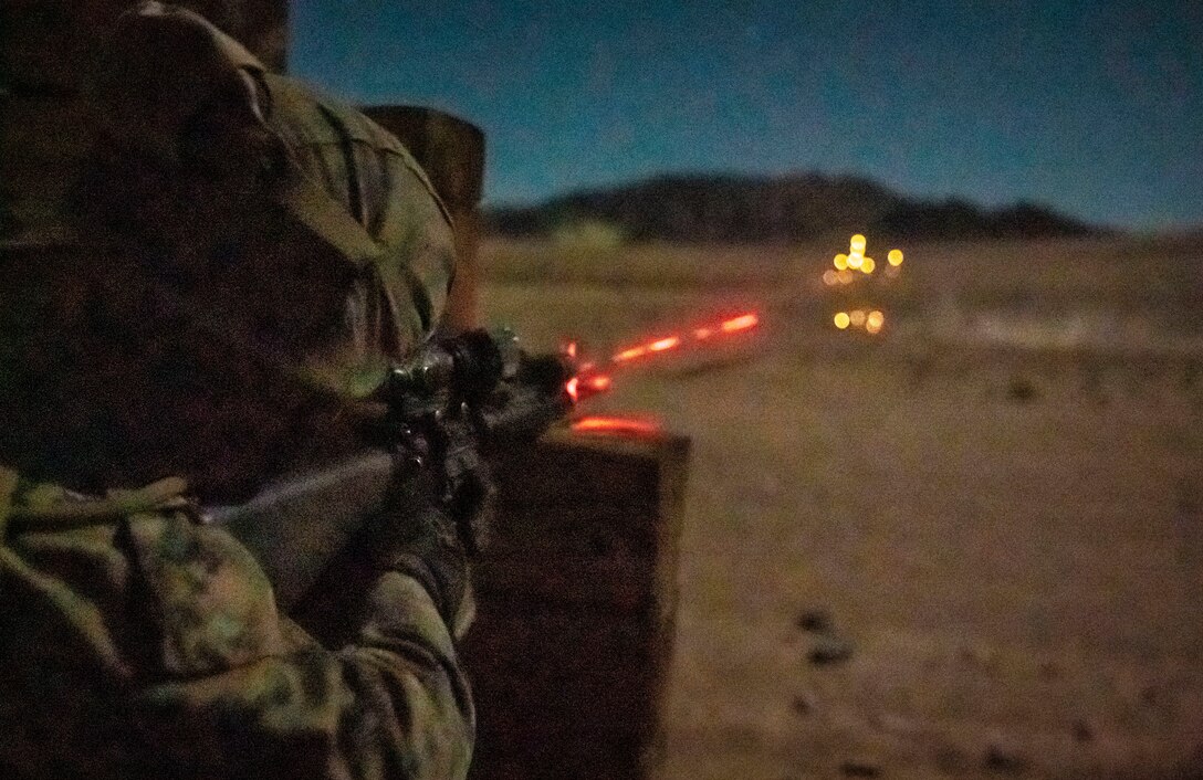 U.S. Marine Corps Lance Cpl. Alejandro Perez, a tank mechanic with Combat Logistics Battalion 11, 11th Marine Expeditionary Unit, fires a M16A4 rifle at targets during a low-light engagement as part of Realistic Urban Training exercise at Marine Corps Air Ground Combat Center Twentynine Palms, California, Feb. 25, 2021. RUT is the final shore-based predeployment training exercise for the 11th MEU, and provides an opportunity to plan and execute operations as a Marine Air-Ground Task Force in urban environments. (U.S. Marine Corps Photo by Cpl. Jaxson Fryar)