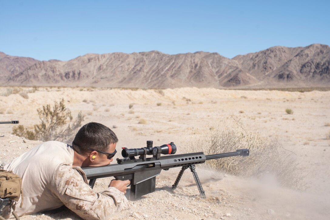 U.S. Marine Corps Sgt. Desmond Tyson, an explosive ordnance technician with Combat Logistics Battalion 11, 11th Marine Expeditionary Unit, fires a M107 .50-caliber Special Applications Scoped Rifle during a surface munition disruption range as part of Realistic Urban Training exercise at Marine Corps Air Ground Combat Center Twentynine Palms, California, Mar. 1, 2021. RUT is the final shore-based predeployment training exercise for the 11th MEU, and provides an opportunity to plan and execute operations as a Marine Air-Ground Task Force in urban environments. (U.S. Marine Corps Photo by Cpl. Jaxson Fryar)