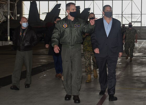 The Honorable James F. Geurts (right), currently performing the duties of Under Secretary of the Navy, tours the hangar bay with Cmdr. Kelly Shekitka (left), executive officer, Strike Fighter Squadron (VFA) 106.