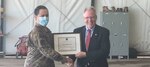 U.S. Air Force Maj. John Harris, 818th Mobility Support Advisory Squadron assistant director of operations, receives a certificate of achievement from David Gilmour, U.S. Embassy N'Djamena chargé d'affaires March 8, 2021, at Adji Kossei Air Base, N’Djamena, Chad. The 818th MSAS helped develop standard operating procedures for the Chadian Air Force AC-208 Combat Caravan aircraft .  (U.S. Army photo by Sgt. 1st Class Joshua Prestel)