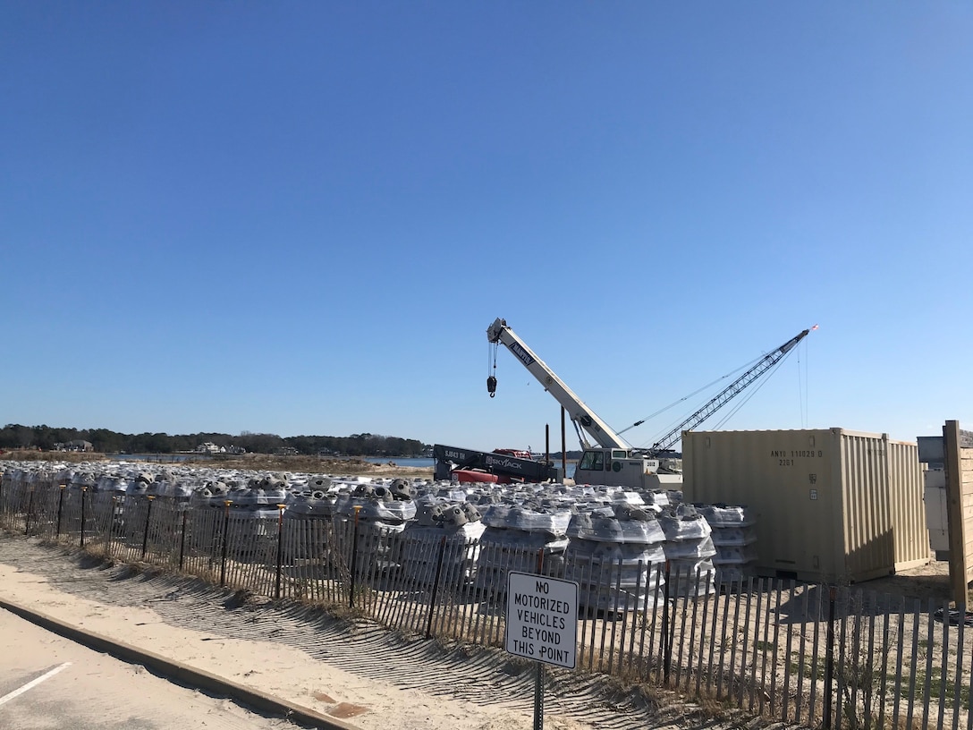 long-distance picture of reef balls and crane on land near the Lesner Bridge in Virginia Beach.