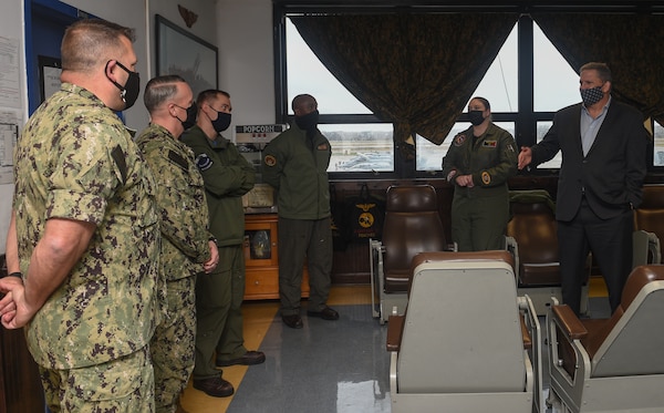 The Honorable James F. Geurts, currently performing the duties of Under Secretary of the Navy, speaks with officers in the ready room of Strike Fighter Squadron (VFA) 106