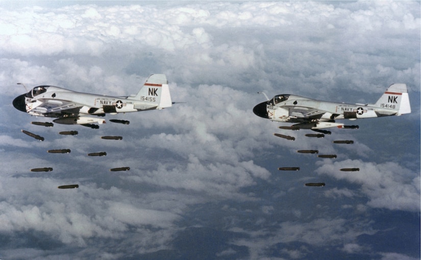 American aircraft drop bombs from above the clouds.