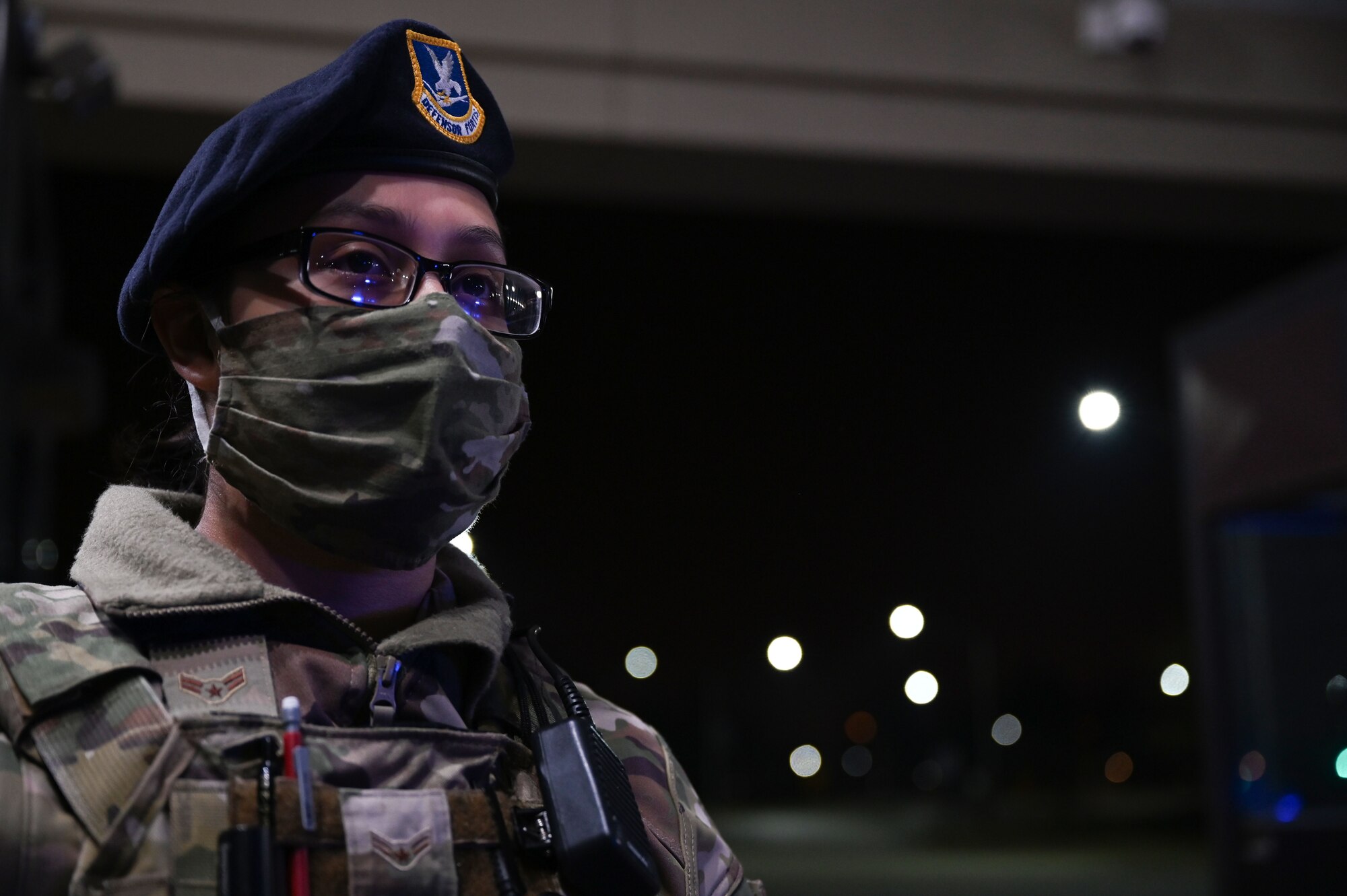 Airman 1st Class Maria Nunez, 375th Security Forces Squadron installation entry controller, motions oncoming personnel at the Shiloh gate forward, March 16, 2021 at Scott Air Force Base, Il. Nunez said one of her favorite parts about the job has been going on calls and interacting with Airmen on base. (U.S. Air Force photo by Senior Airman Dalton Williams)