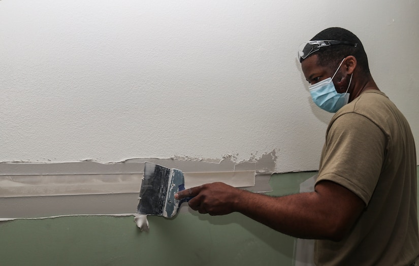 Tech Sgt. Pierre Givens, 628th Civil Engineer Squadron structural craftsman, puts on joint compound on the walls at Dyess Air Force Base, Texas, Mar. 9, 2021. Airmen who are structural specialists construct and repair any buildings and other structures from the foundation up.