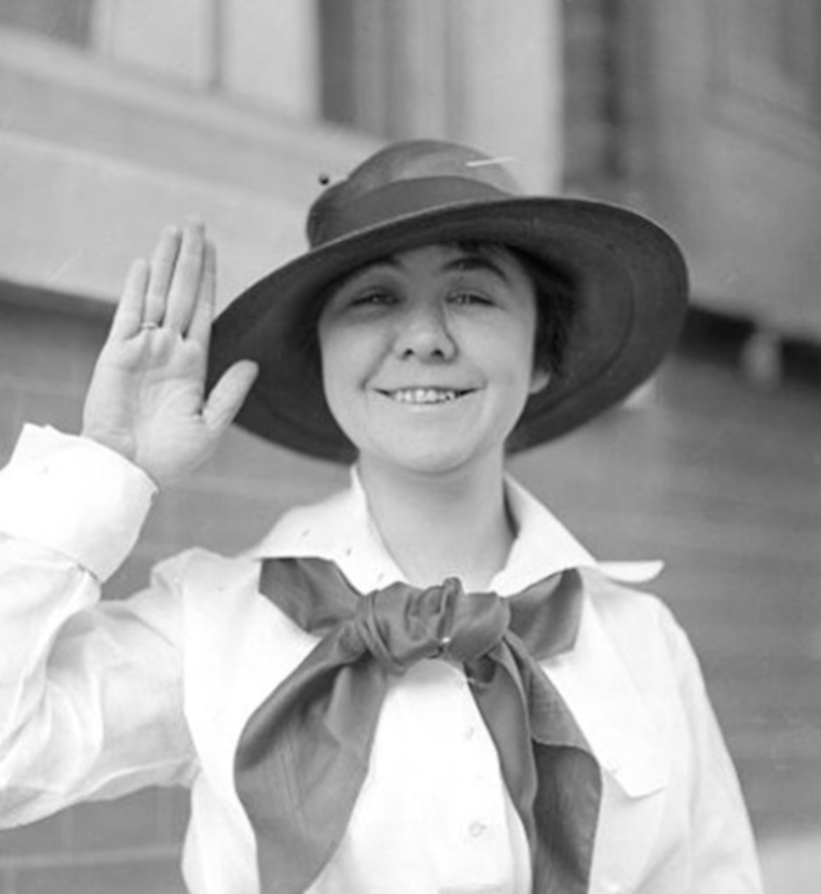 A woman waves for the camera.