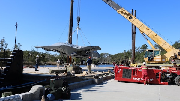 Transportation specialist move a stripped-down F-35 airframe.