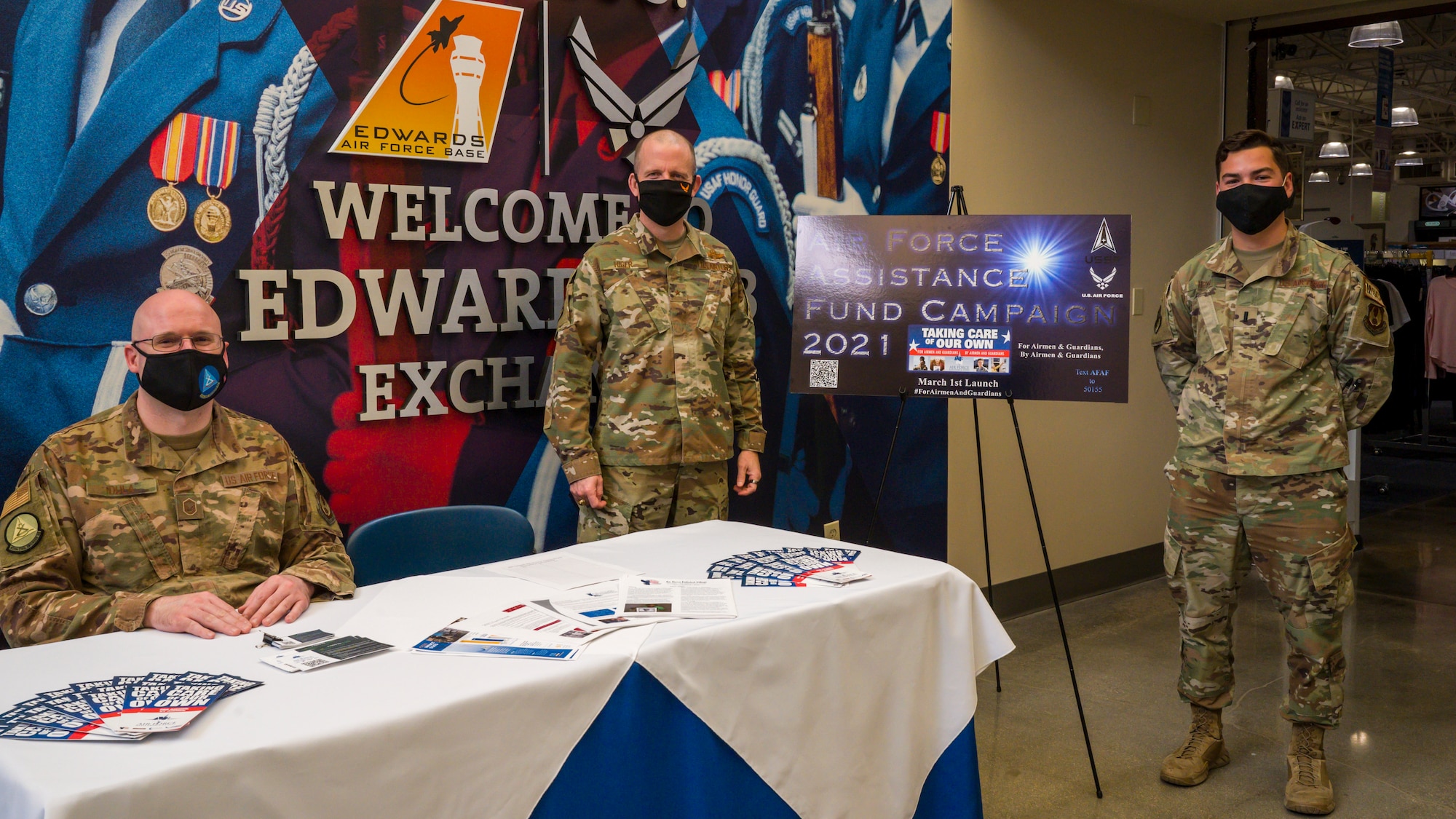 Brig. Gen. Matthew higer, 412th Test Wing Commander (center), poses for members of the base Air Force Assistance Fund campaign team, Master Sgt. Richard Dula and 1st Lt. Remington Hoyer, at Edwards Air Force Base, California, March 22. (Air Force photo by Giancarlo Casem)