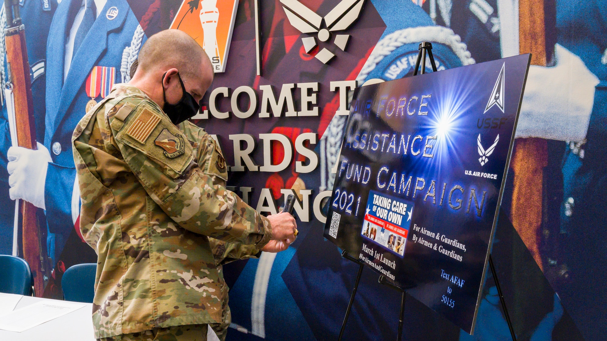 Brig. Gen. Matthew Higer, 412th Test Wing Commander, scans the QR code for the Air Force Assistance Fund on his cell phone at Edwards Air Force Base, California, March 22. The campaign, titled “For Airmen & Guardians, By Airmen & Guardians," runs until April 30. (Air Force photo by Giancarlo Casem)