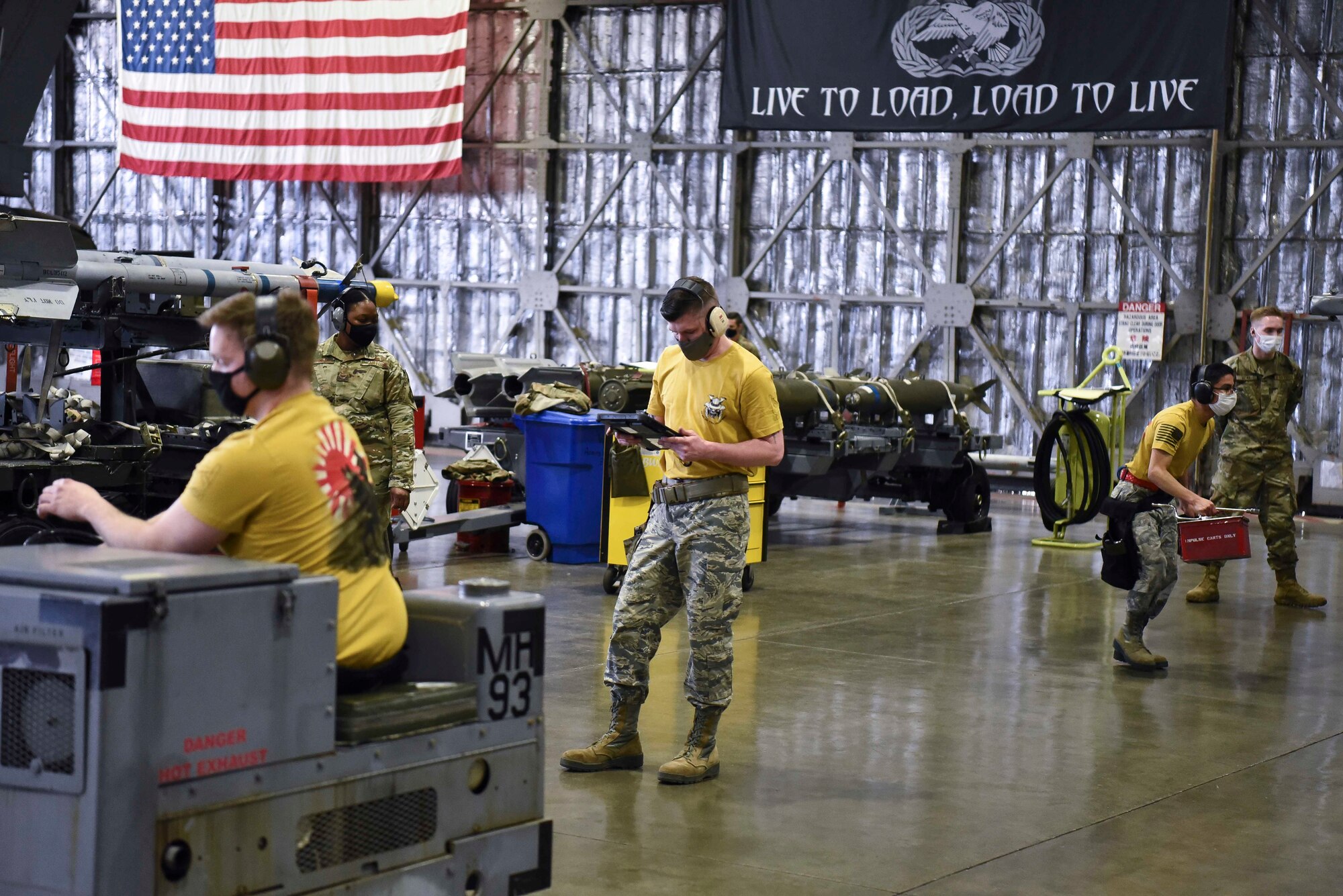 Airmen with the 14th Aircraft Maintenance Unit prepare to load weapons during the fourth quarterly load competition at Misawa Air Base, Japan, March 19, 2021.