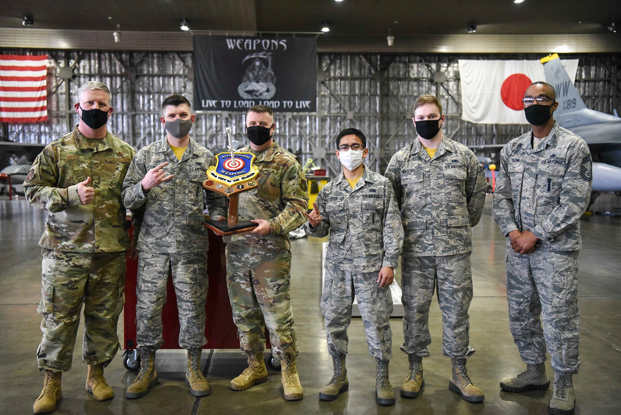 U.S. Air Force Airmen with the 14 Aircraft Maintenece Unit recieve a trophy after winning the fourth quarterly load compitition at Misawa Air Base, Japan, March 19, 2021.