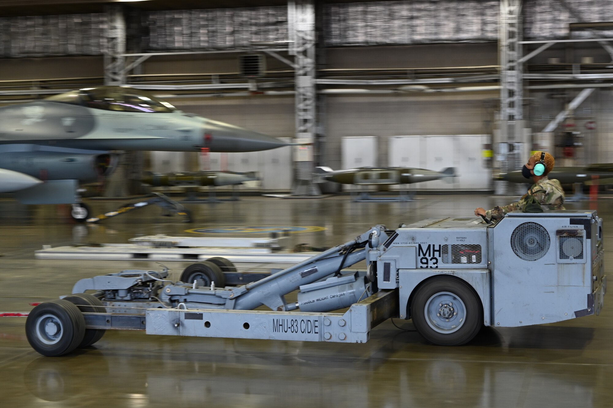 Senior Airman JoAnn Morgan, a 13th Aircraft Maintenance Unit weapons load crew member, drives a MJ-1 bomb lift truck during the 35th Aircraft Maintenance Squadron’s fourth quarter load competition at Misawa Air Base, Japan, Mar. 19, 2021.