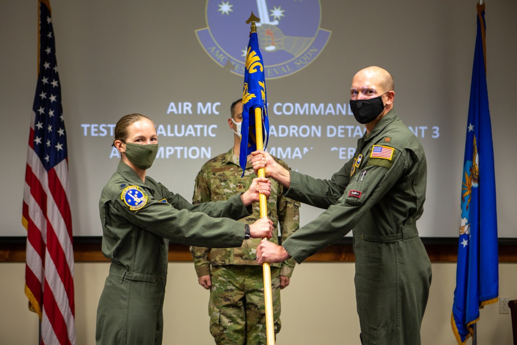 Major Jacob C. Johnson, the new commander of Detachment 3 Air Mobility Command Test and Evaluation Squadron, receives the unit guidon from Lt. Col. Maryann Karlen, AMC TES commander, during an Assumption of Command ceremony March 15, at Edwards Air Force Base, California. (Air Force photo by Senior Master Sgt. Alexander Berry)