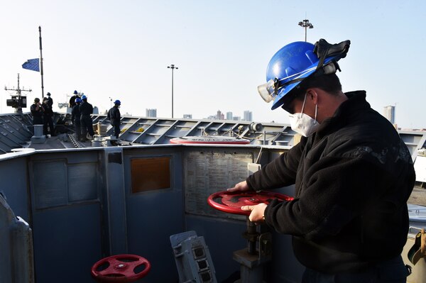 210321-N-IE405-1145 MANAMA, Bahrain (March 21, 2021) - Seaman Nikalus Wagley, assigned to guided-missile cruiser USS Philippine Sea (CG 58), checks the anchor chain brake during a sea and anchor detail prior to the ship departing from Manama, Bahrain, March 21. Philippine Sea is deployed to the U.S.  5th Fleet area of operations in support of naval operations to ensure maritime stability and security in the Central Region, connecting the Mediterranean and Pacific through the western Indian Ocean and three critical chokepoints to the free flow of global commerce. (U.S. Navy photo by Mass Communication Specialist 2nd Class Indra Beaufort/Release)