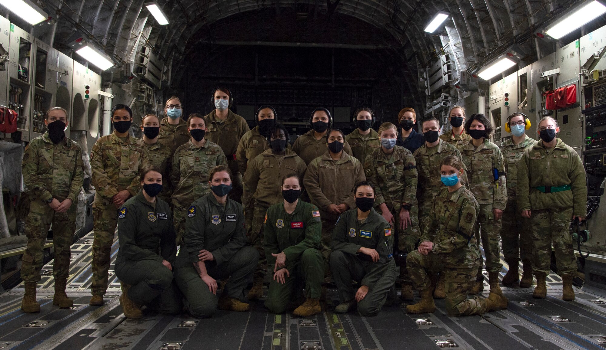 Team McChord Airmen pose for a group photo inside a C-17 Globemaster III at Joint Base Lewis-McChord, Washington, Dec. 14, 2020. The all-female crew prepared, launched and executed a flight-training mission in honor of women in the military. (U.S. Air Force photo by Senior Airman Tryphena Mayhugh)