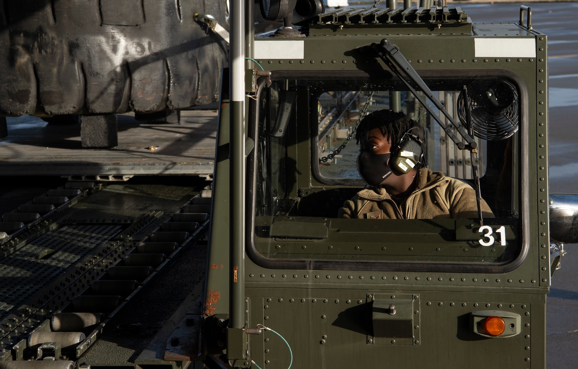 U.S. Air Force Senior Airman Briana Antoine, 62nd Aerial Port Squadron airfreight journeyman, drives a K-loader to the ramp of a C-17 Globemaster III at Joint Base Lewis-McChord, Washington, Dec. 14, 2020. Antoine and other Team McChord Airmen participated in an all-female training mission to honor women in the Air Force. (U.S. Air Force photo by Senior Airman Tryphena Mayhugh)
