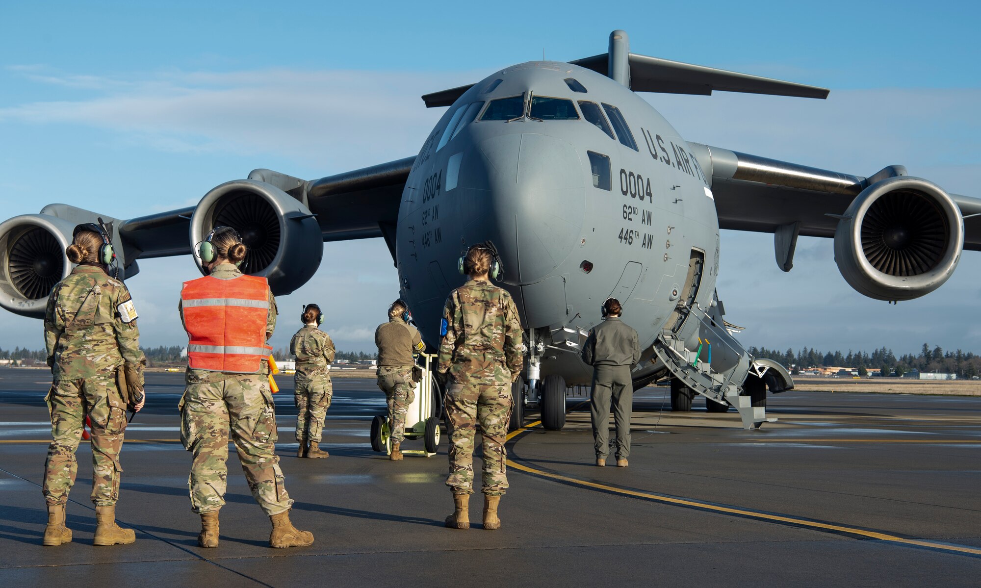 Airmen with the 62nd Airlift Wing conduct an engine-start for a C-17 Globemaster III during an all-female flight-training mission at Joint Base Lewis-McChord, Washington, Dec. 14, 2020. Every Airman involved in the preparation, launch and execution of the mission was female to honor women in the Air Force. (U.S. Air Force photo by Senior Airman Tryphena Mayhugh)