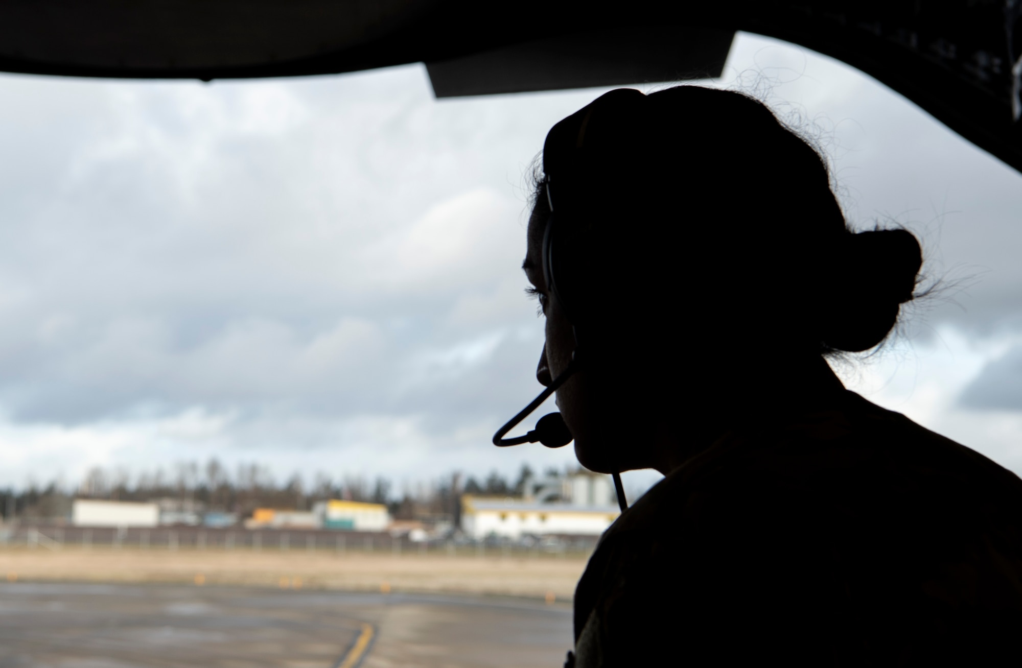 U.S. Air Force Tech. Sgt. Jaideep Kaur, 7th Airlift Squadron Operations Flight flight chief, watches out the back of a C-17 Globemaster III for 90-degree backing training with the aircraft during an all-female training mission at Joint Base Lewis-McChord, Washington, Dec. 14, 2020. Every Airman involved in the preparation, launch and execution of the mission was female to honor women in the Air Force. (U.S. Air Force photo by Senior Airman Tryphena Mayhugh)