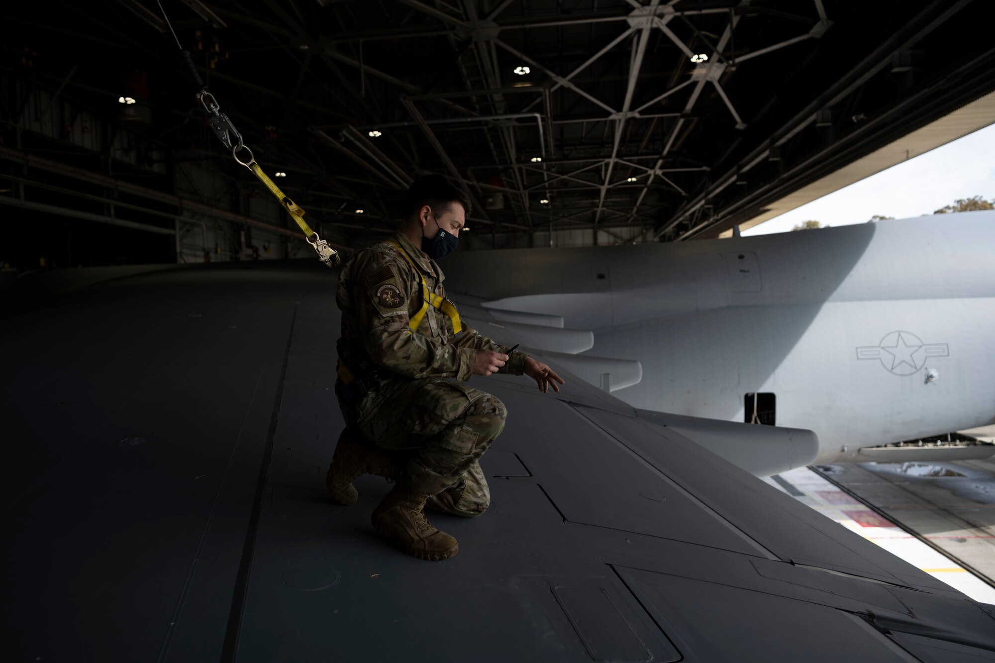 U.S. Air Force Staff Sgt. Jacob Hall, 60th Aircraft Maintenance Squadron home station check dock controller, points at the wing during a left wing inspection on a C-5M Super Galaxy March 19, 2021, at Travis Air Force Base, California. Airmen collaborated with the Air Staff Logistics Directorate’s Tesseract team and key partners from the C-5 program office to implement commercial maintenance practices in scheduling and completing maintenance around flying demands. (U.S. Air Force photo by Airman 1st Class Alexander Merchak)