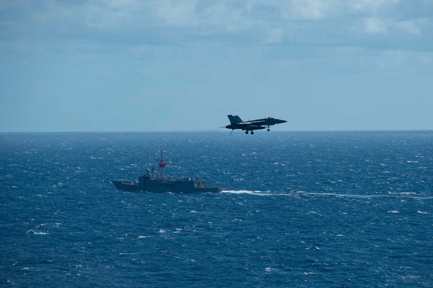 The Turkish frigate TCG Gemlik (F 492) sails alongside the Nimitz-class aircraft carrier USS Dwight D. Eisenhower (CVN 69) during flight operations in the Mediterranean Sea.