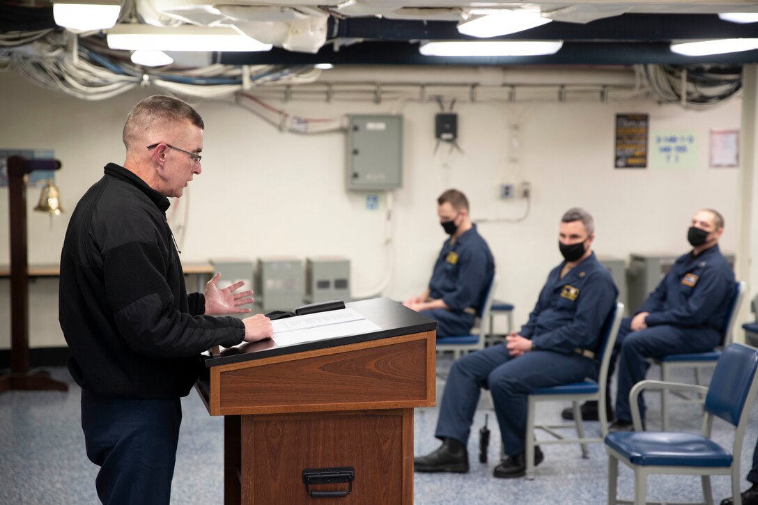 Cmdr. Charles Johnson, command chaplain of the aircraft carrier USS Gerald R. Ford (CVN 78), addresses Sailors assigned to Ford's legal, training and command religious ministries departments during an extremism standdown training.