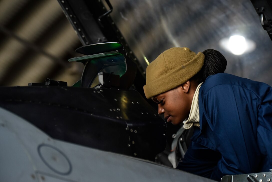 A crew chief inspects an aircraft before flight.