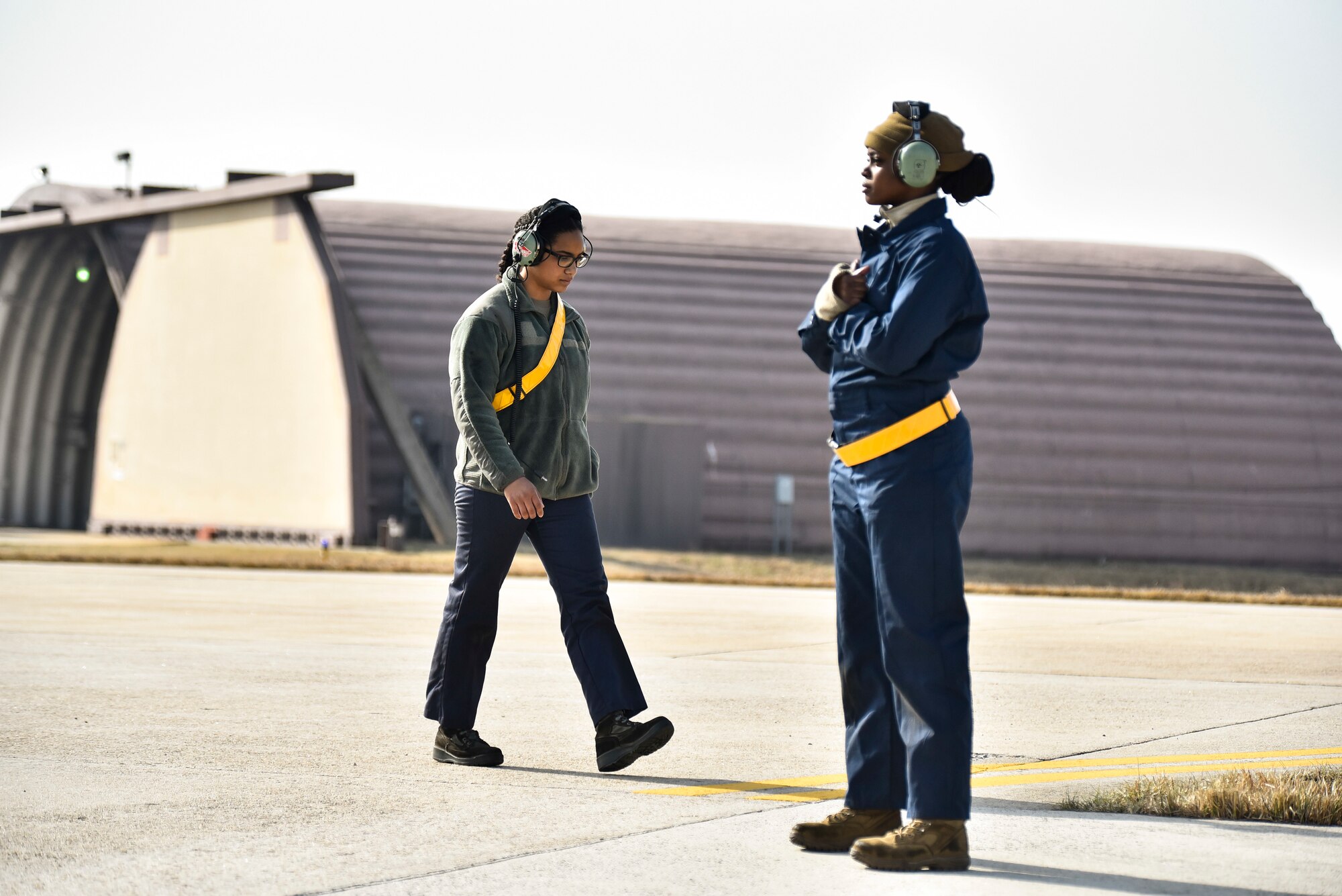 Crew chiefs wait for an F-16 to takeoff.