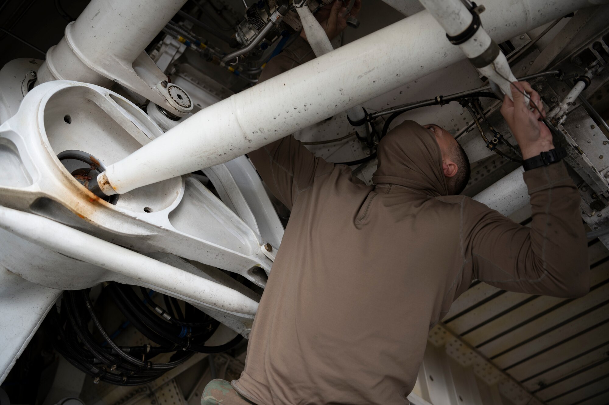 Senior Airman Angel Estevez, 60th Aircraft Maintenance Squadron crew chief, inspects the main landing gear of a C-5M Super Galaxy March 19, 2021, at Travis Air Force Base, California. Airmen collaborated with the Air Staff Logistics Directorate’s Tesseract team and key partners from the C-5 program office to implement commercial maintenance practices in scheduling and completing maintenance around flying demands. (U.S. Air Force photo by Airman 1st Class Alexander Merchak)