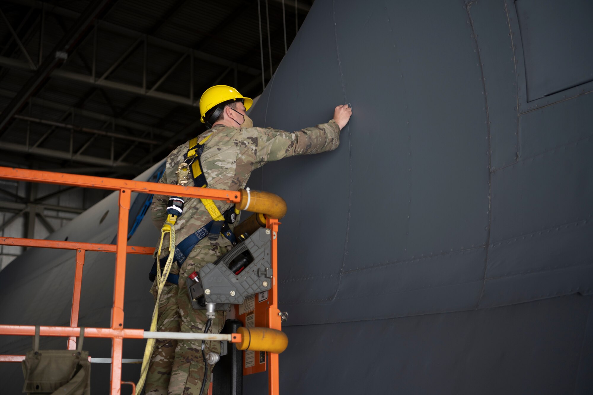 U.S. Air Force Staff Sgt. Joshua Wyatt, 60th Aircraft Maintenance Squadron home station check lead dock controller, marks areas to be fixed on a C-5M Super Galaxy during an exterior pylon inspection March 19, 2021, at Travis Air Force Base, California. Airmen collaborated with the Air Staff Logistics Directorate’s Tesseract team and key partners from the C-5 program office to implement commercial maintenance practices in scheduling and completing maintenance around flying demands.  (U.S. Air Force photo by Airman 1st Class Alexander Merchak)