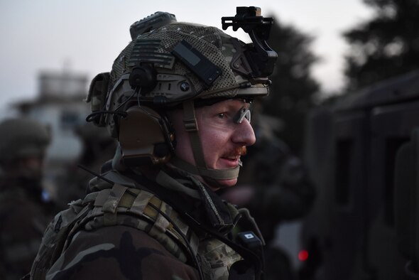 Staff Sgt. Alex Hahne, 8th Security Forces Squadron Base Defense Operations Center controller, talks to another Defender at Kunsan Air Base, Republic of Korea, March 22, 2021. Security forces members go through extensive training in law enforcement and combat tactics to protect bases both stateside and overseas. (U.S. Air Force photo by Senior Airman Suzie Plotnikov)