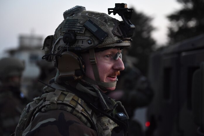 Staff Sgt. Alex Hahne, 8th Security Forces Squadron Base Defense Operations Center controller, talks to another Defender at Kunsan Air Base, Republic of Korea, March 22, 2021. Security forces members go through extensive training in law enforcement and combat tactics to protect bases both stateside and overseas. (U.S. Air Force photo by Senior Airman Suzie Plotnikov)