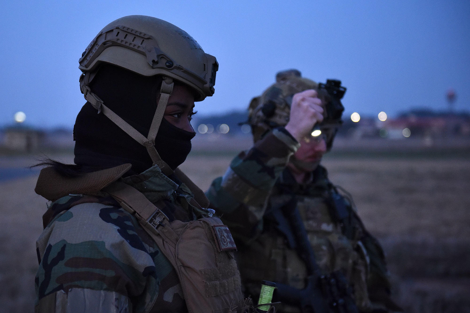 Airman 1st Class Annissia Thomas, 8th Security Forces Squadron alarm monitor, and Staff Sgt. Alex Hahne, 8th SFS Base Defense Operations Center controller, search for foreign objects during a routine training event at Kunsan Air Base, Republic of Korea, March 22, 2021. Security Forces members go through extensive training in law enforcement and combat tactics to protect bases both stateside and overseas. (U.S. Air Force photo by Senior Airman Suzie Plotnikov)