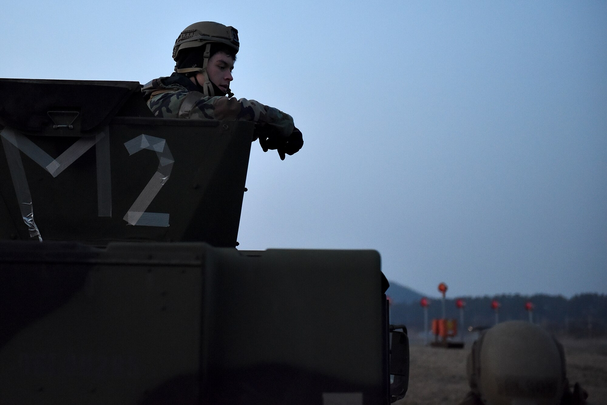 Airman David Harrison, 8th Security Forces Squadron entry controller, talks to another Defender at Kunsan Air Base, Republic of Korea, March 22, 2021. Security Forces members go through extensive training in law enforcement and combat tactics to protect bases both stateside and overseas. (U.S. Air Force photo by Senior Airman Suzie Plotnikov)