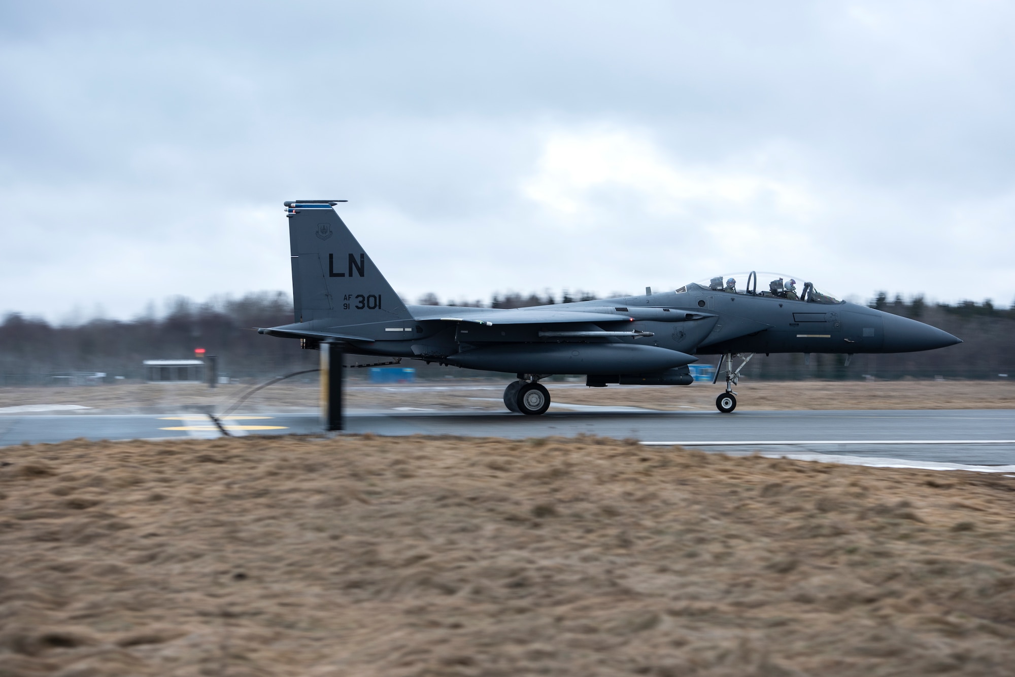 An F-15E Strike Eagle assigned to the 492nd Fighter Squadron catches the cable of an aircraft arresting system during a Barrier Arresting Kit certification at Ämari Air Base, Estonia, March 17, 2021. The BAK is certified annually to test the stability and effectiveness of the system, which acts as a braking mechanism to stop the aircraft in the event of an emergency that would prevent the aircraft from performing a standard landing. (U.S. Air Force photo by Airman 1st Class Jessi Monte)